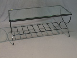 A Designer rectangular iron framed coffee table raised on X framed supports with plate glass top  39"