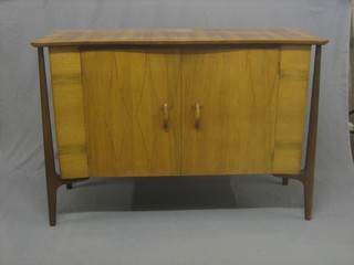 A 1950's walnut Designer sideboard fitted 2 cupboards enclosed by panelled doors by Everest 54" 