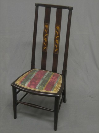 An Art Nouveau inlaid mahogany stick and rail back bedroom chair with upholstered seat