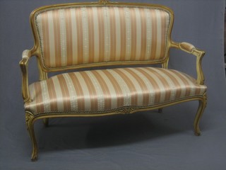 An Empire style sofa upholstered in Regency stripe, raised on cabriole supports 48"