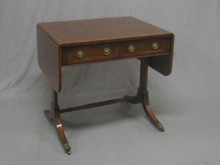 A handsome Georgian style mahogany sofa table fitted 2 drawers, raised on standard end supports united by a turned stretcher 29"