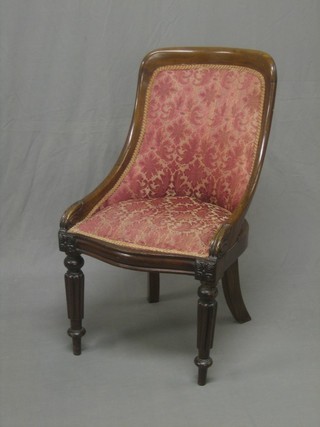 A William IV mahogany tub back chair raised on turned and reeded supports