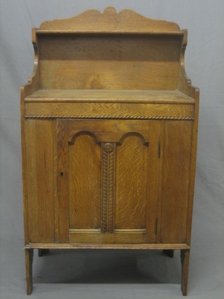 An aesthetic movement oak chiffonier with raised back, the base fitted a cupboard enclosed by panelled doors 24"