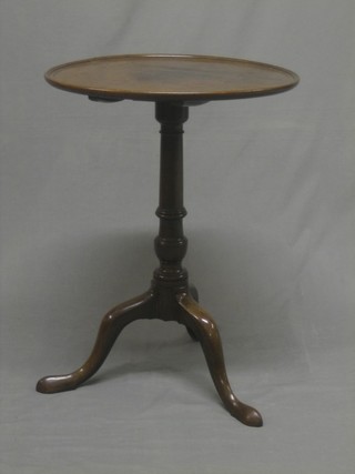 A 19th Century circular mahogany dish top wine table, raised on turned column and tripod supports 21" (crack to top) 