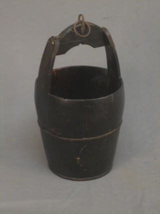 A reproduction wooden and iron well bucket