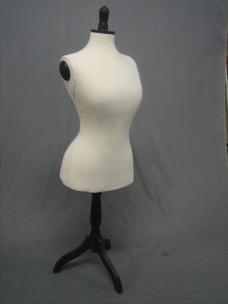 A white fabric mannequin and stand