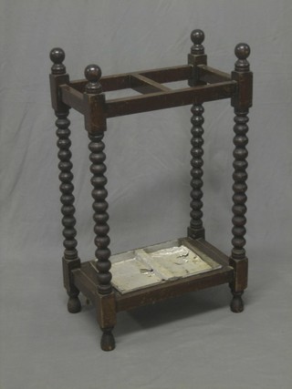 A rectangular oak umbrella stand with bobbin turned decoration complete with drip tray 18"