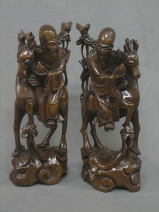 A pair of Eastern carved rootwood figures of mounted Deity's 15"