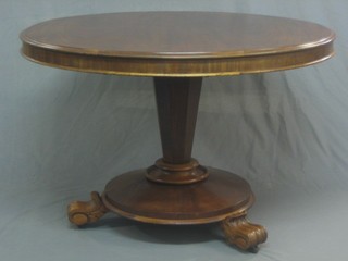 A Victorian circular mahogany snap top breakfast table raised on a chamfered column ending in scroll feet 42" 