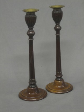 A handsome pair of mahogany turned and reeded candlesticks with detachable brass sconces 13" (1 f and r)