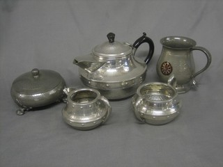 A Craftsman planished pewter 3 piece tea service comprising teapot, sugar bowl and milk jug, a circular planished jar and cover and a pewter tankard 