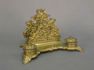 A cast brass double inkwell incorporating a pierced stationery rack 8"