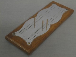 An oak and chromium plated cribbage board 