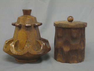 A cylindrical carved wooden pipe rack and a tobacco jar