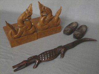 A pair of carved wooden bookends, a figure of a crocodile 16", 2 small carved wooden clogs 4"