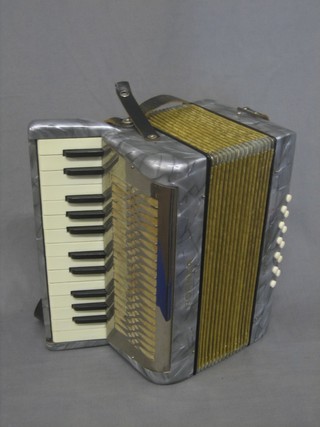 A Hohner Mignon II accordion with 12 buttons