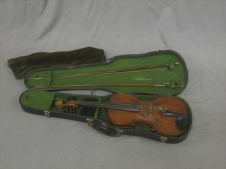 A 19th Century violin with 13 1/2" back, the scroll carved a lions mask (unlabelled) contained in a fibre carrying case with 2 bows
