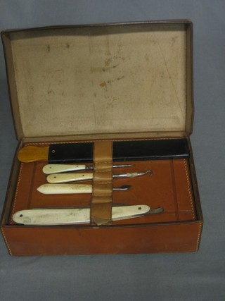 An Edwardian Gentleman's travelling shaving kit contained in a leather case comprising mirror, cut throat razor, strop and manicure implements 