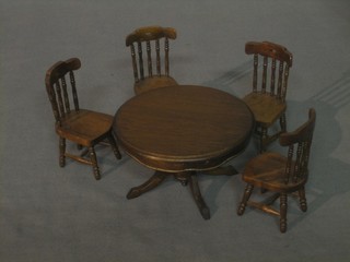 A dolls house circular mahogany pedestal dining table and 4 chairs