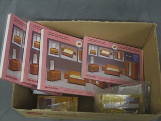 A box containing various unmade up dolls house furniture, all boxed and as new