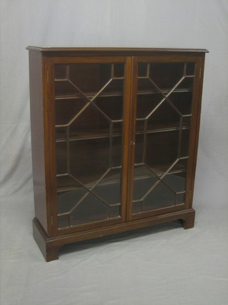 A mahogany display cabinet fitted adjustable shelves enclosed by astragal glazed panelled doors, raised on bracket feet 36"