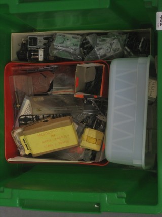 A collection of various railway component parts etc contained in a green plastic box