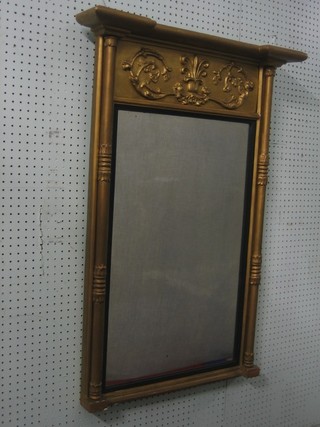 A Regency rectangular plate wall mirror contained in a decorative gilt frame supported by columns 28"