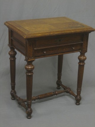 A 19th Century French carved oak work table with revolving top, the base fitted a fitted drawer above 1 long drawer, raised on turned and reeded supports with H framed stretcher 25"