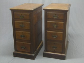 A pair of Victorian walnut pedestal chests of 4 long drawers raised on a platform base 15"