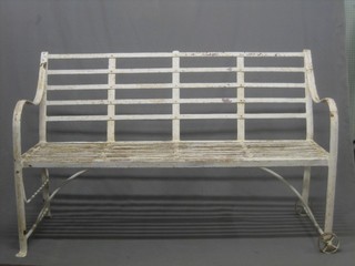 A Regency style iron garden bench on rollers 60" 