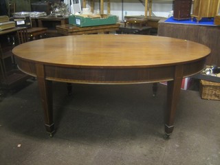 An Edwardian Georgian style oval dining table raised on square tapering supports ending in spade feet 72"