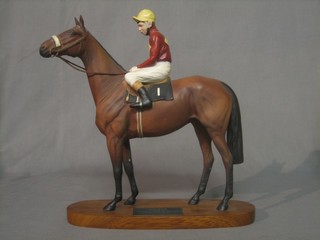A Beswick figure of  Red Rum with Jockey Up, raised on a wooden base 12" 