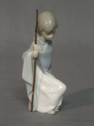 A Lladro figure of a seated girl with stick, the base impressed B22E 6"