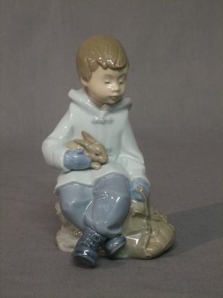 A Nao figure of a seated boy with rabbit 6"