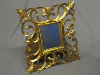 A square plate mirror contained in an ornate decorative gilt frame 9" x 11"