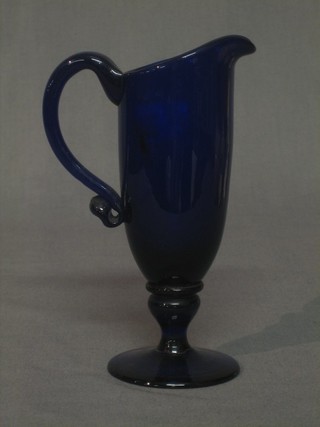 A 19th Century Bristol blue glass jug raised on a spreading foot 7"