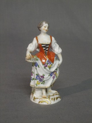 A Meissen figure in the form of a lady gardener, the base with sword mark and 940 A 49 5"