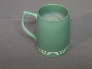 A Wedgwood green glazed Keith Murray tankard, the base marked Keith Murray and impressed E (chips and restored to base) 5"
