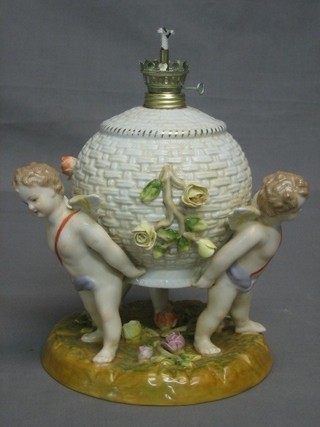 A Continental porcelain oil lamp base supported by 3 cherubs 8"