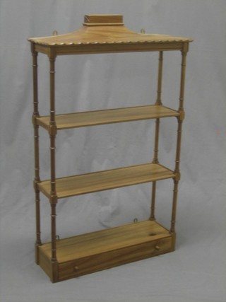 A Georgian style bleached mahogany hanging 3 tier what-not with turned and block supports, the base fitted a drawer 22"