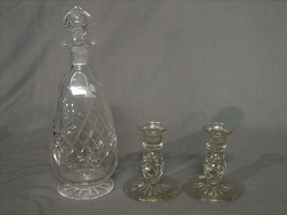 A club shaped decanter and stopper 12" together with a pair of circular glass stub candlesticks 5" 
