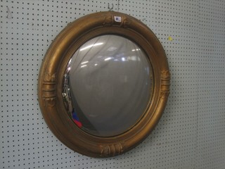 A Regency convex plate mirror contained in a decorative gilt frame 24"