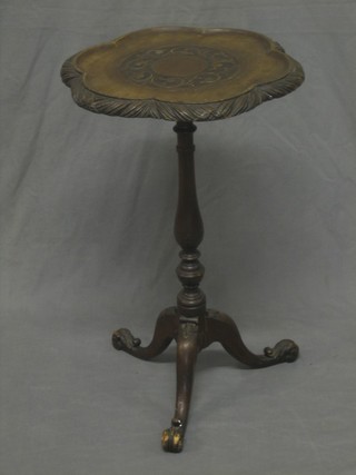 A 19th Century carved mahogany wine table raised on pillar and tripod supports 14" 