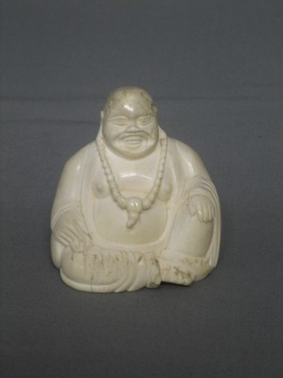 A carved ivory figure of a seated Buddha (some chips to head)