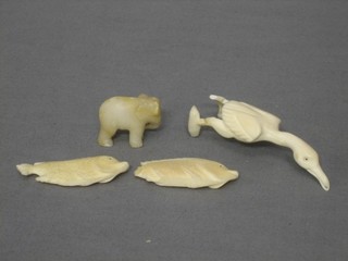 A carved ivory figure of a bird 3", 2 carved ivory figures of fishes 2" and a figure of an elephant 1" 
