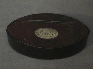 A 19th Century oval leather snuff box with hinged lid inset an oval silver panel