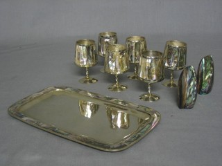 A rectangular white metal dish with abalone banding, 6 white metal and abalone goblets and a pair of abalone salts