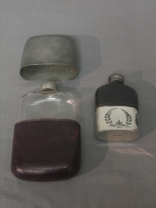 A silver plated and glass hip flask and a pewter and glass hip flask