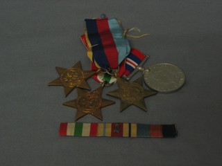 A group of 4 medals comprising 1939-45 Star, Africa Star, Italy Star, British Warm medal and together with a ribbon bar