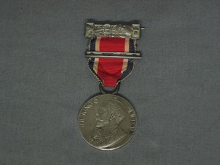 A silver School Attendance medal